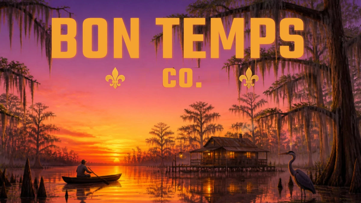 Bon Temps Tee Co. - Louisiana bayou at sunset with mossy cypress trees, a camp on stilts, a heron and a pirogue